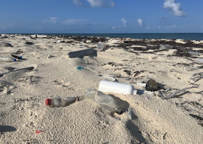 Envases de plástico sobre la arena en una de las playas de Tulum (México). AGUSTINA GRASSO